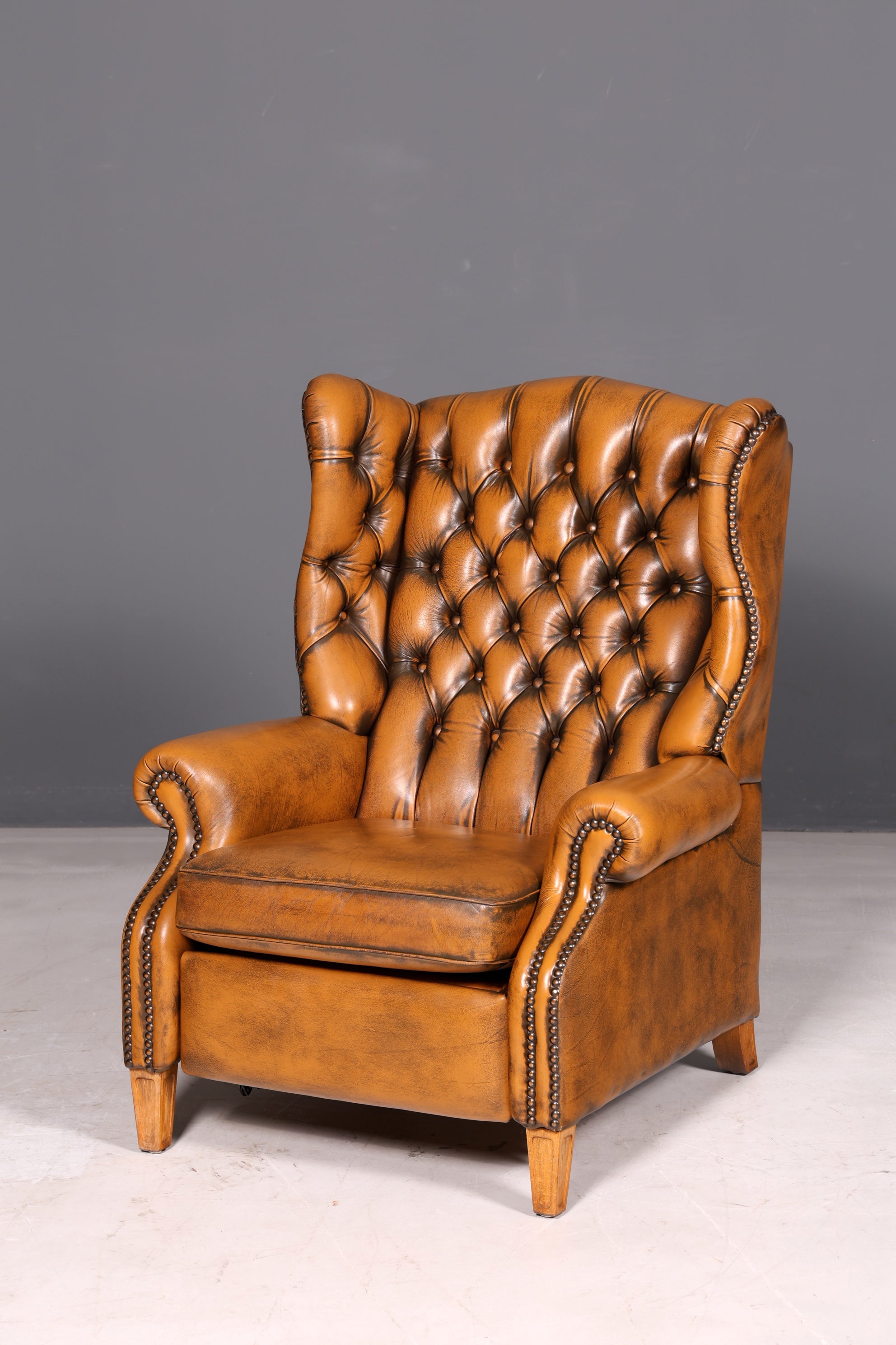 Beautiful original Chesterfield wingback armchair, English genuine leather gentleman’s chair, recliner with reclining function, vintage