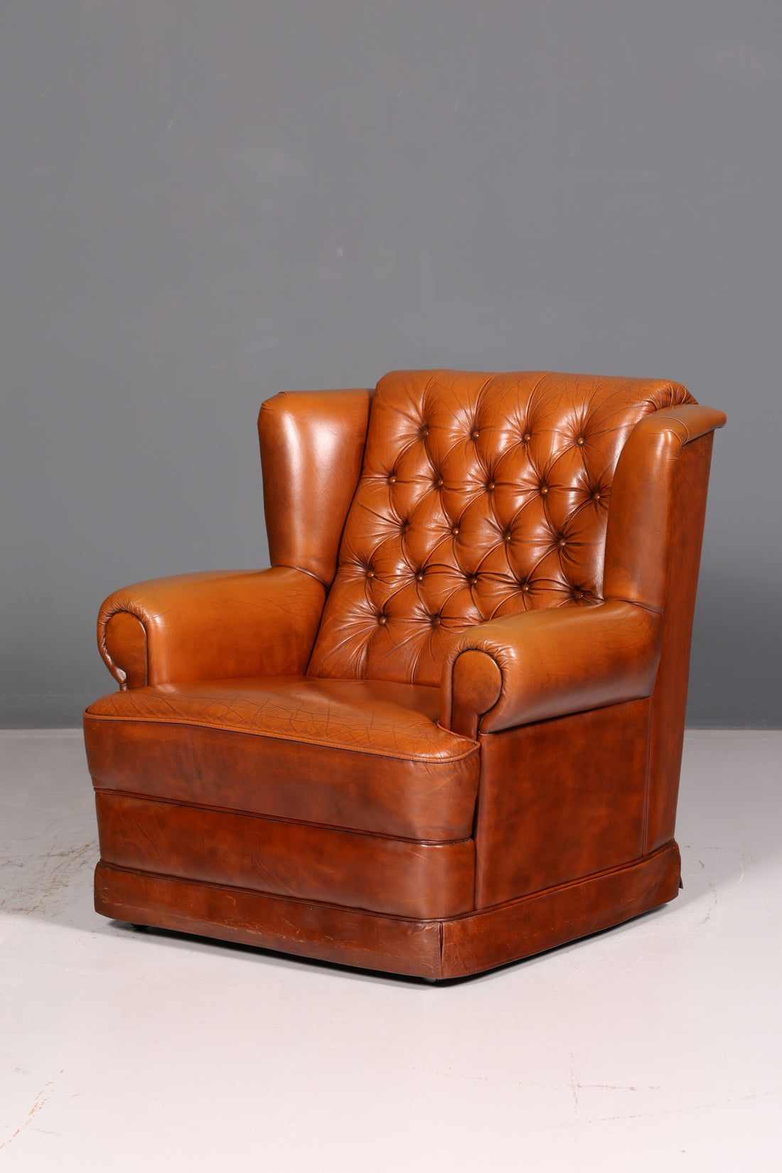 Stylish original Chesterfield armchair, English leather armchair in cognac genuine leather, gentleman&