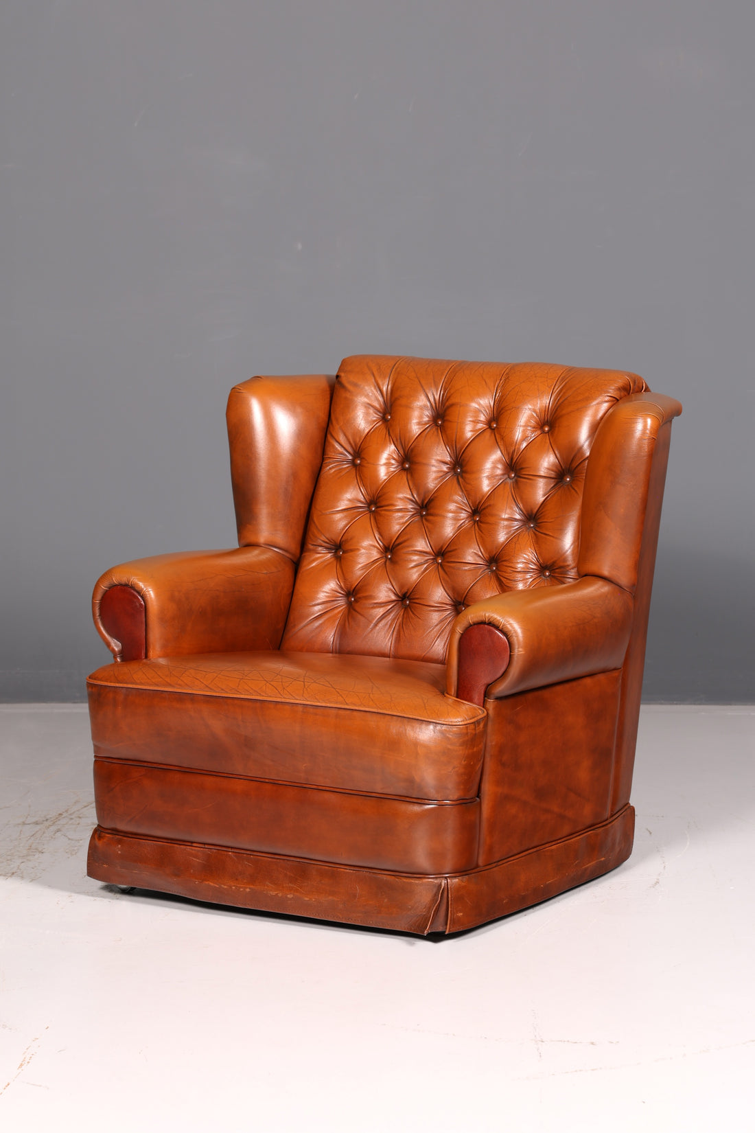 Stylish original Chesterfield armchair, English leather armchair in cognac genuine leather, gentleman&