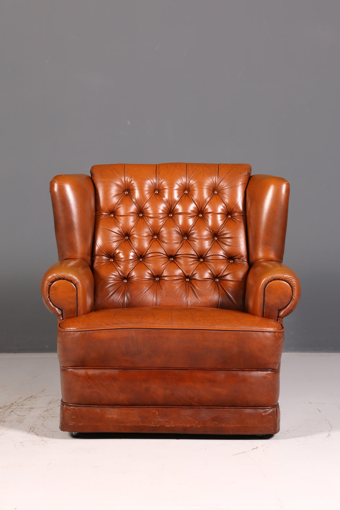 Stylish original Chesterfield armchair, English leather armchair in cognac genuine leather, gentleman&