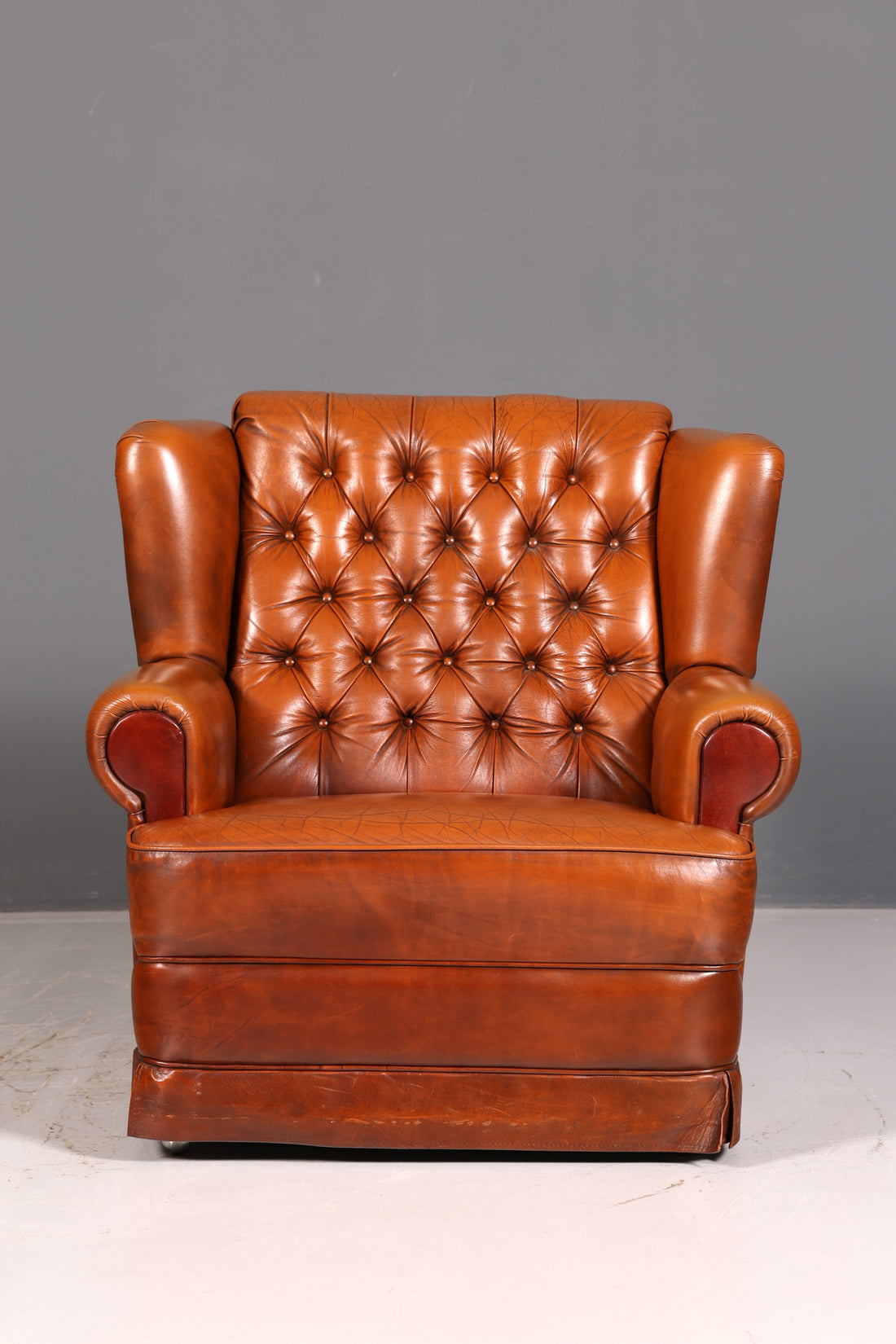 Stylish original Chesterfield armchair, English leather armchair in cognac genuine leather, gentleman&