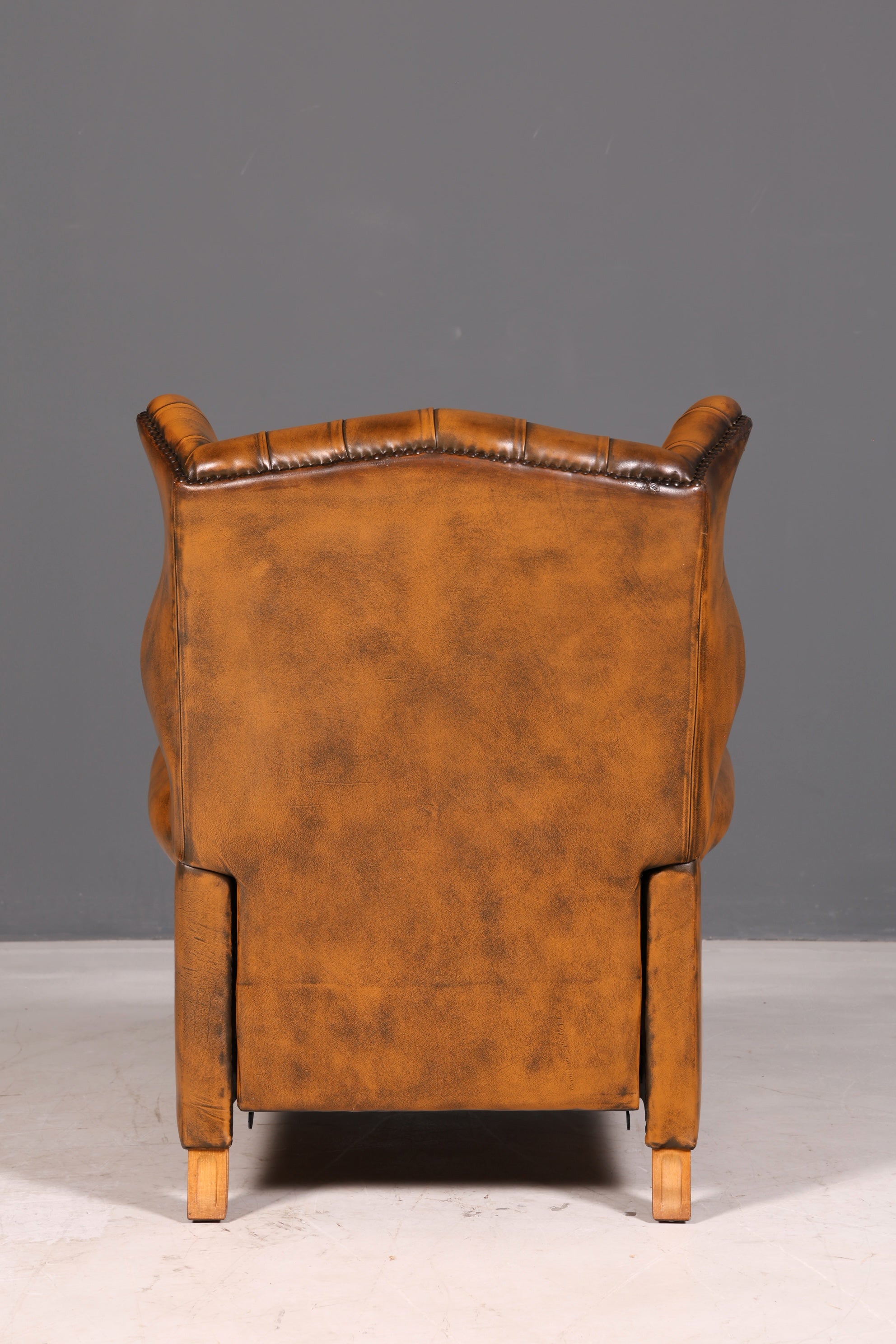 Beautiful original Chesterfield wingback armchair, English genuine leather gentleman’s chair, recliner with reclining function, vintage