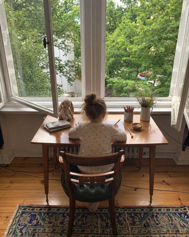 Desk with green leather chair by the window